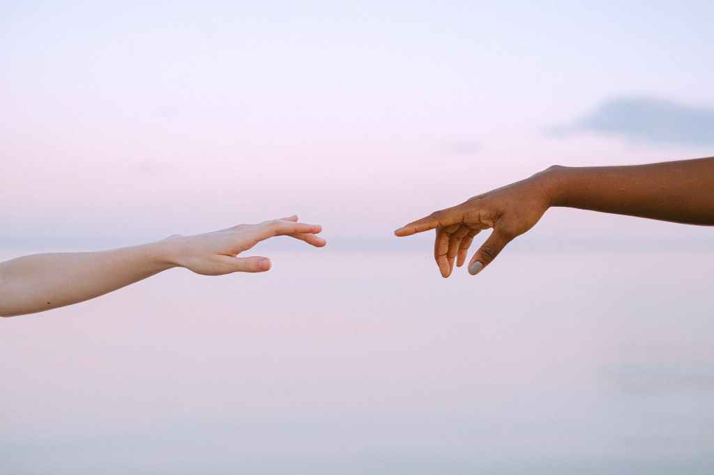 Hands reaching for unity.